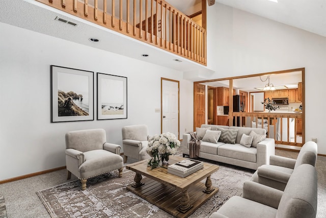 carpeted living room with a towering ceiling