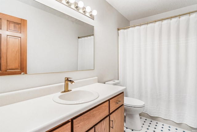 bathroom featuring vanity, a textured ceiling, and toilet