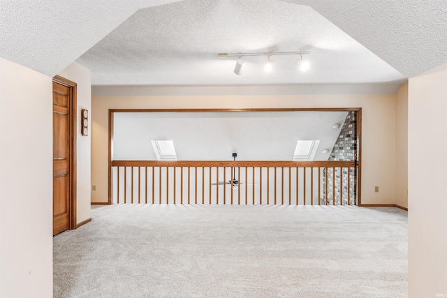 interior space featuring carpet flooring and a textured ceiling