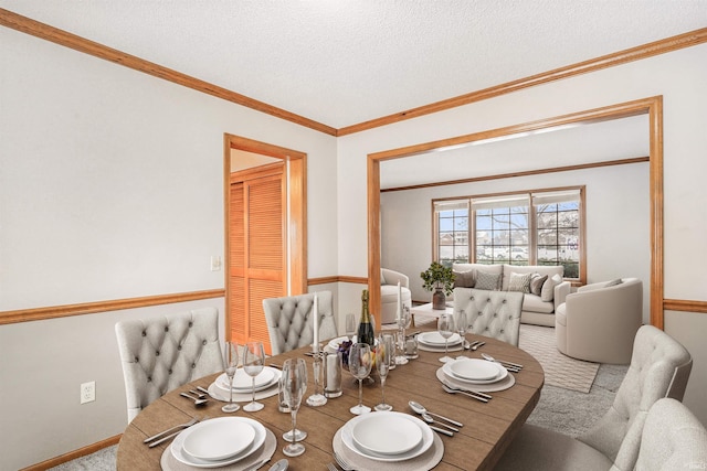 dining space with crown molding, light colored carpet, and a textured ceiling