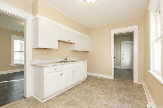 kitchen with white cabinetry and sink