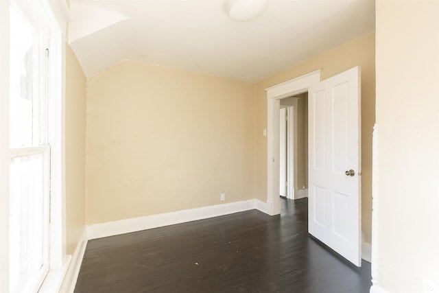 empty room with dark wood-type flooring