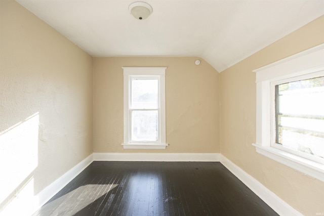 bonus room with dark wood-type flooring and lofted ceiling