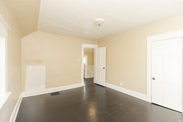 empty room featuring dark wood-type flooring