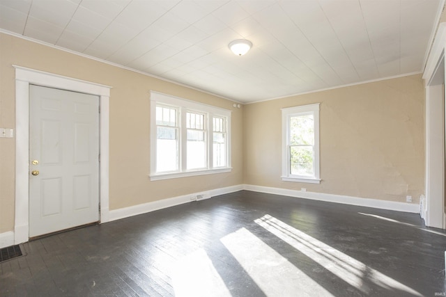 spare room featuring crown molding and dark wood-type flooring