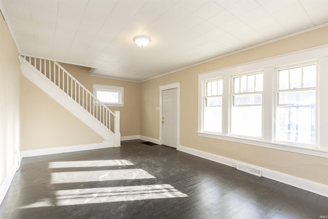 entrance foyer with crown molding and dark wood-type flooring