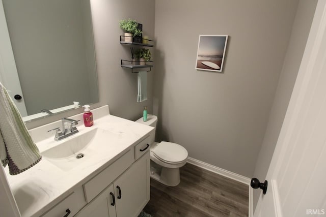 bathroom featuring vanity, toilet, and wood-type flooring