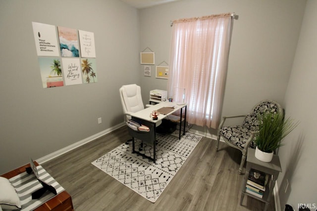 office area with a wealth of natural light and dark hardwood / wood-style floors