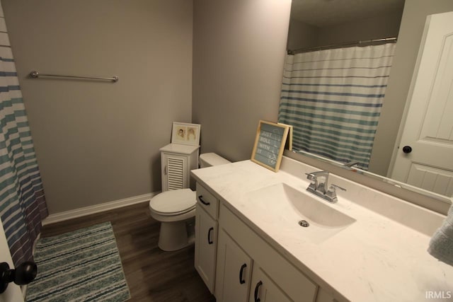 bathroom with a shower with shower curtain, vanity, hardwood / wood-style flooring, and toilet