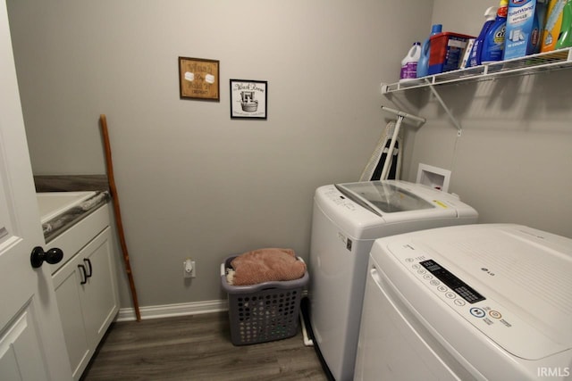 laundry area featuring cabinets, independent washer and dryer, and dark wood-type flooring