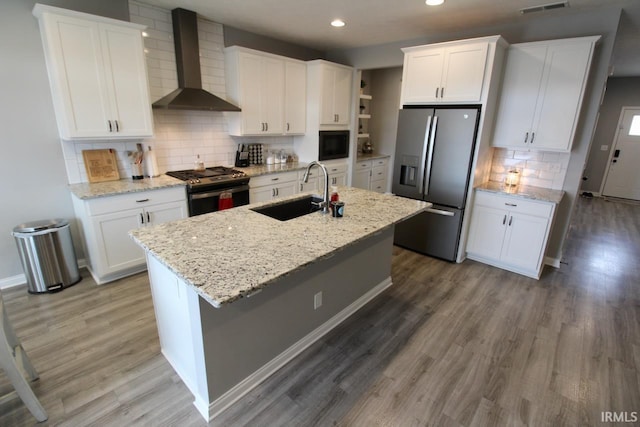 kitchen featuring white cabinets, sink, wall chimney exhaust hood, and stainless steel appliances