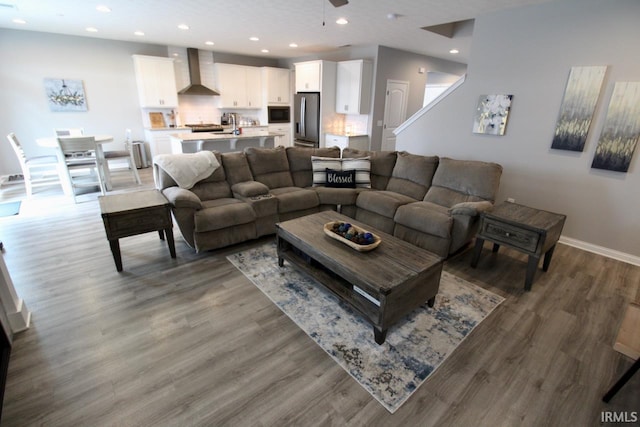 living room featuring hardwood / wood-style flooring and ceiling fan