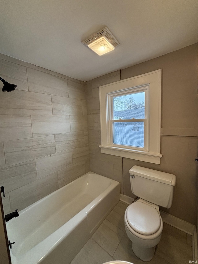 bathroom with tile patterned floors, toilet, and a bathtub