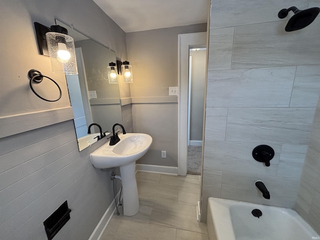 bathroom featuring tile patterned floors, tiled shower / bath combo, and sink