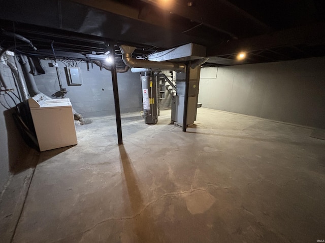 basement with heating unit, electric panel, washer / clothes dryer, and water heater