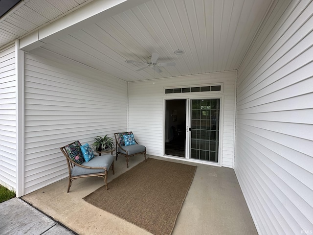 entrance to property with a patio area and ceiling fan