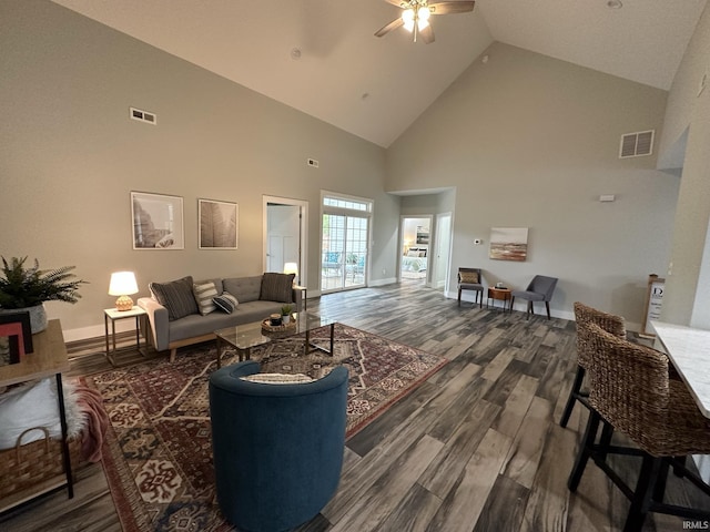 living room with dark hardwood / wood-style floors, ceiling fan, and high vaulted ceiling