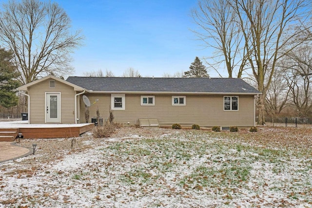 snow covered property featuring a wooden deck