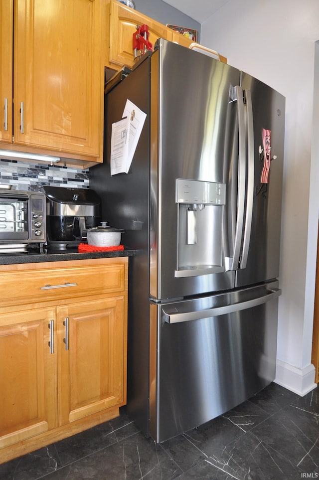 kitchen featuring tasteful backsplash and stainless steel fridge with ice dispenser