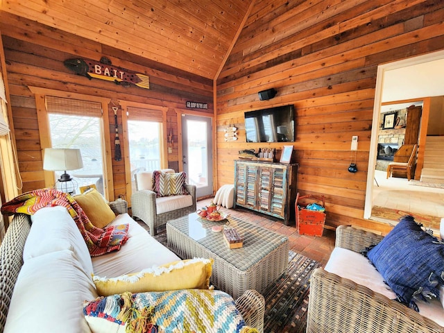 living room with wooden ceiling, wooden walls, and vaulted ceiling