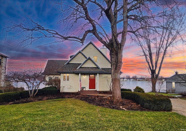 view of front of house featuring a water view and a yard