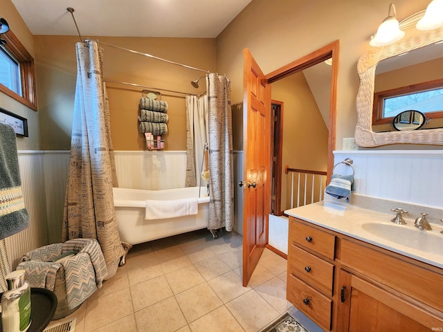 bathroom with shower / tub combo with curtain, tile patterned flooring, vanity, and vaulted ceiling