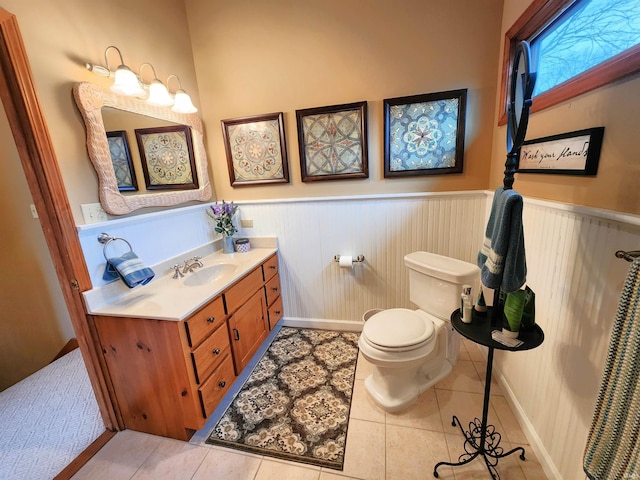 bathroom with tile patterned flooring, vanity, and toilet