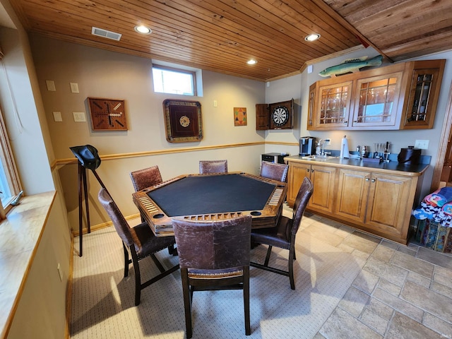 recreation room featuring indoor wet bar and wood ceiling