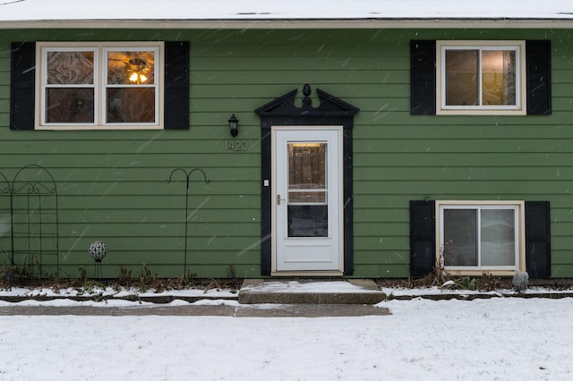 view of snow covered property entrance