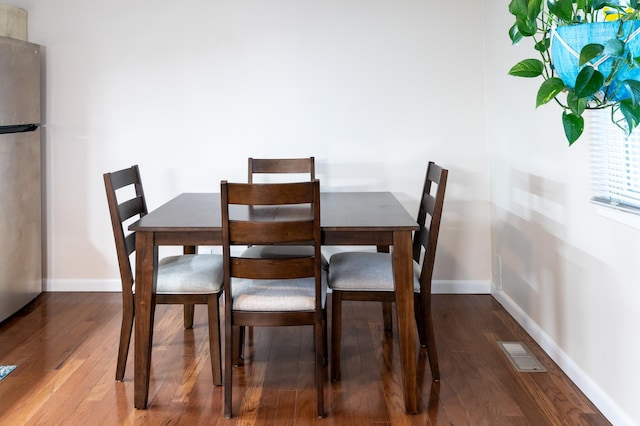 dining room with hardwood / wood-style flooring