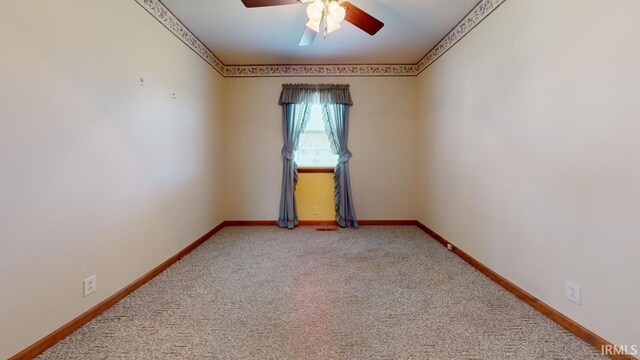 spare room featuring carpet and ceiling fan