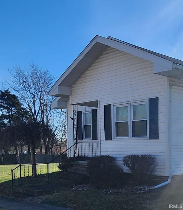 view of property exterior with a yard