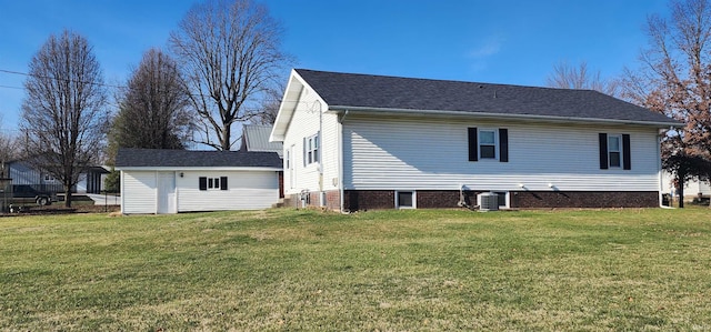 back of property featuring central AC and a yard