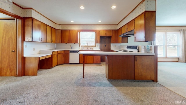 kitchen featuring range, white dishwasher, sink, light colored carpet, and kitchen peninsula