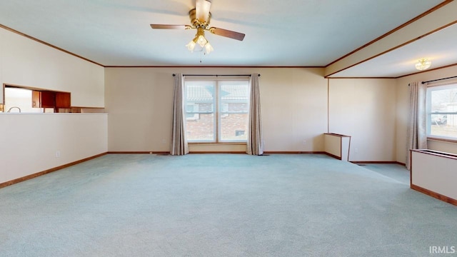 carpeted empty room featuring ceiling fan and ornamental molding