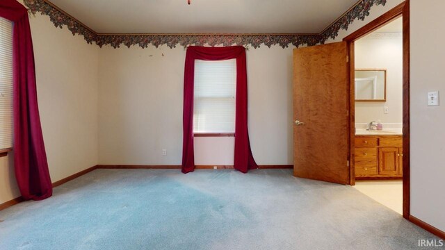 carpeted spare room featuring sink