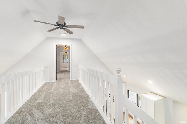 hallway featuring carpet floors and vaulted ceiling