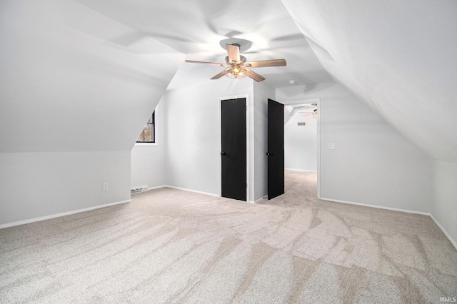 bonus room with ceiling fan, light carpet, and vaulted ceiling