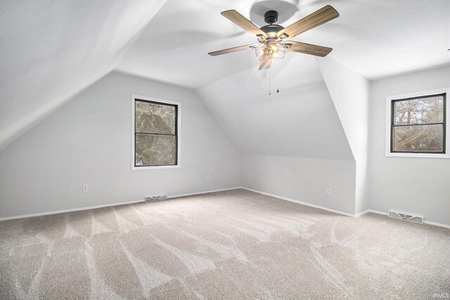 bonus room with ceiling fan, carpet floors, and a healthy amount of sunlight