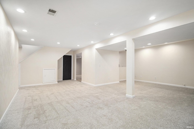 basement featuring light carpet