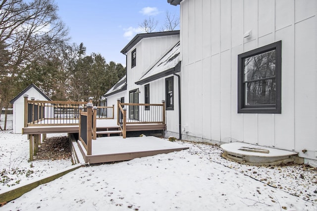 view of snowy exterior featuring a deck