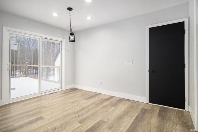 unfurnished dining area with wood-type flooring