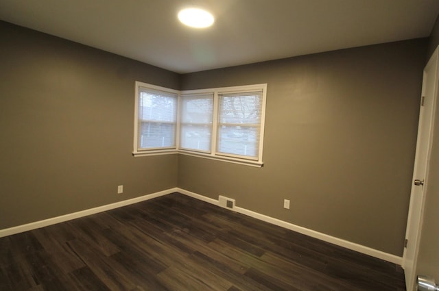 spare room with dark hardwood / wood-style floors