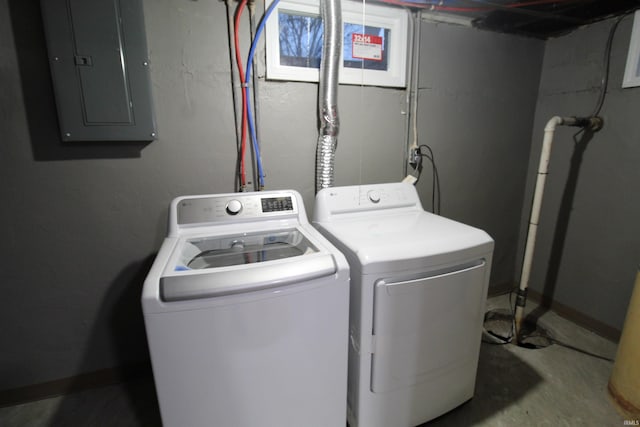 clothes washing area featuring washer and clothes dryer and electric panel