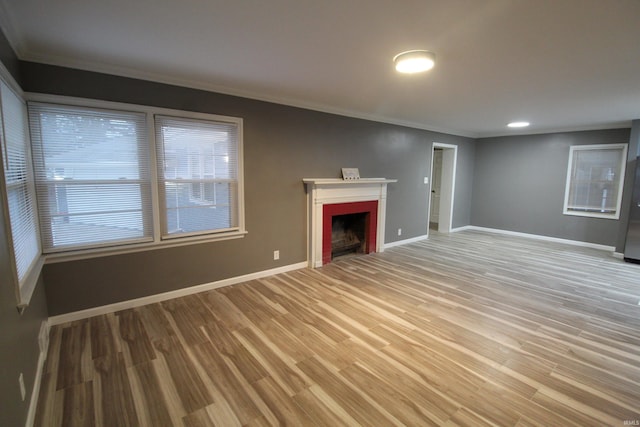 unfurnished living room with hardwood / wood-style floors and ornamental molding