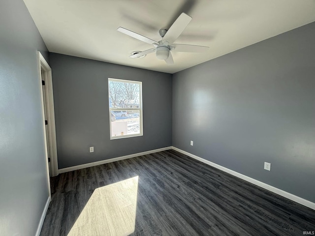 empty room with dark hardwood / wood-style floors and ceiling fan