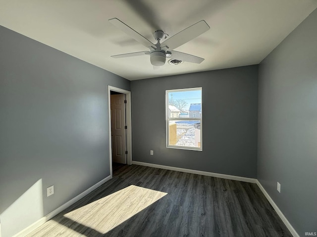 spare room with ceiling fan and dark hardwood / wood-style flooring