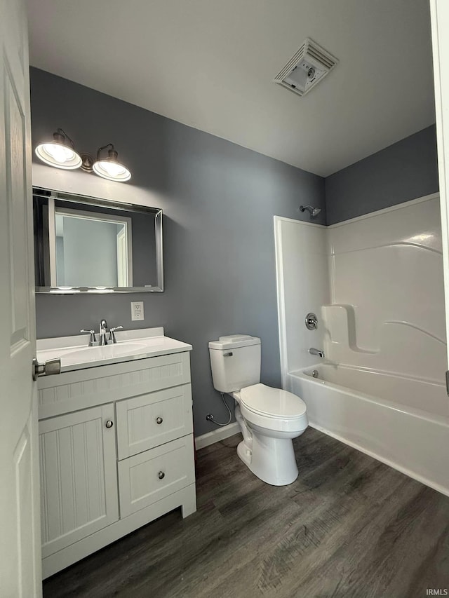 full bathroom featuring vanity, shower / bathtub combination, toilet, and wood-type flooring