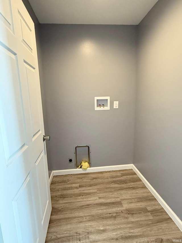 laundry area featuring washer hookup, electric dryer hookup, and hardwood / wood-style flooring