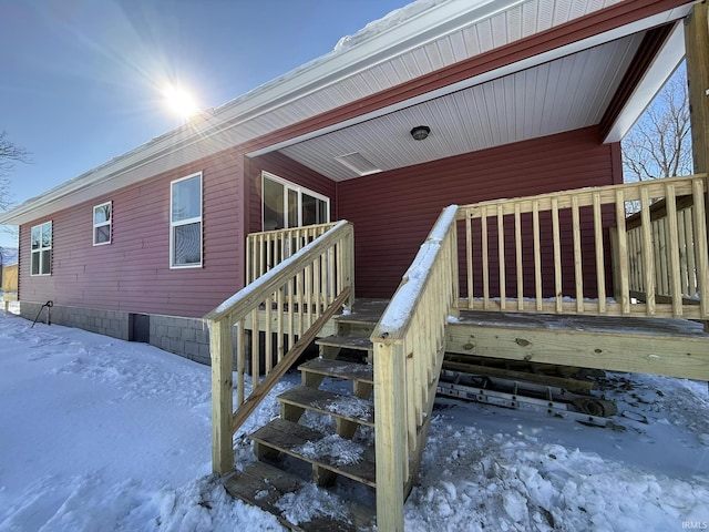 view of snow covered property entrance